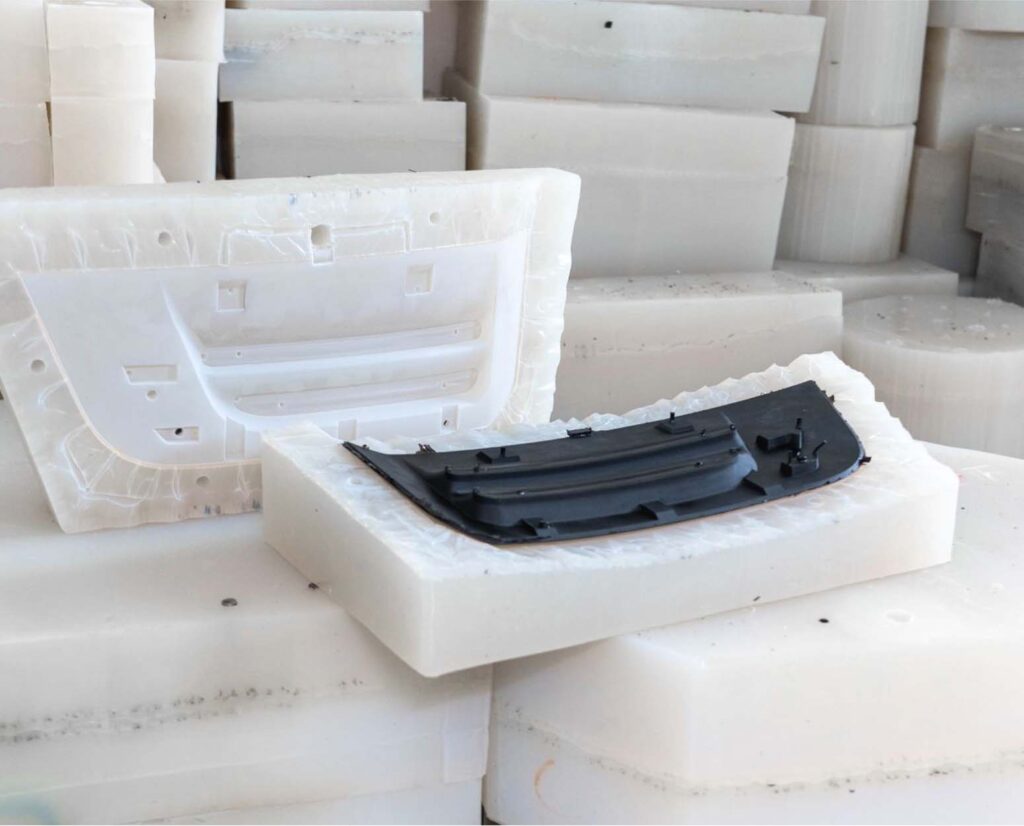 silicone mold being prepared from master pattern in vacuum casting process with comparison cast parts